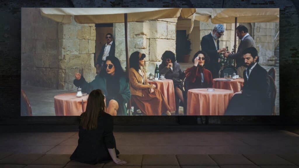 Visitors seated in front of Charlie Cauchi’s Dolce at Malta’s pavilion